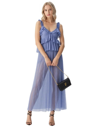 Woman wearing a blue skirt s holding a black handbag on a white backgroundt